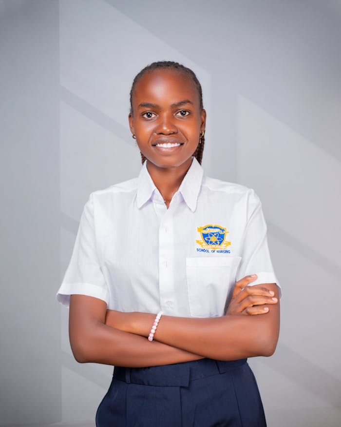 Portrait of a young woman in school uniform with a confident expression, indoors.